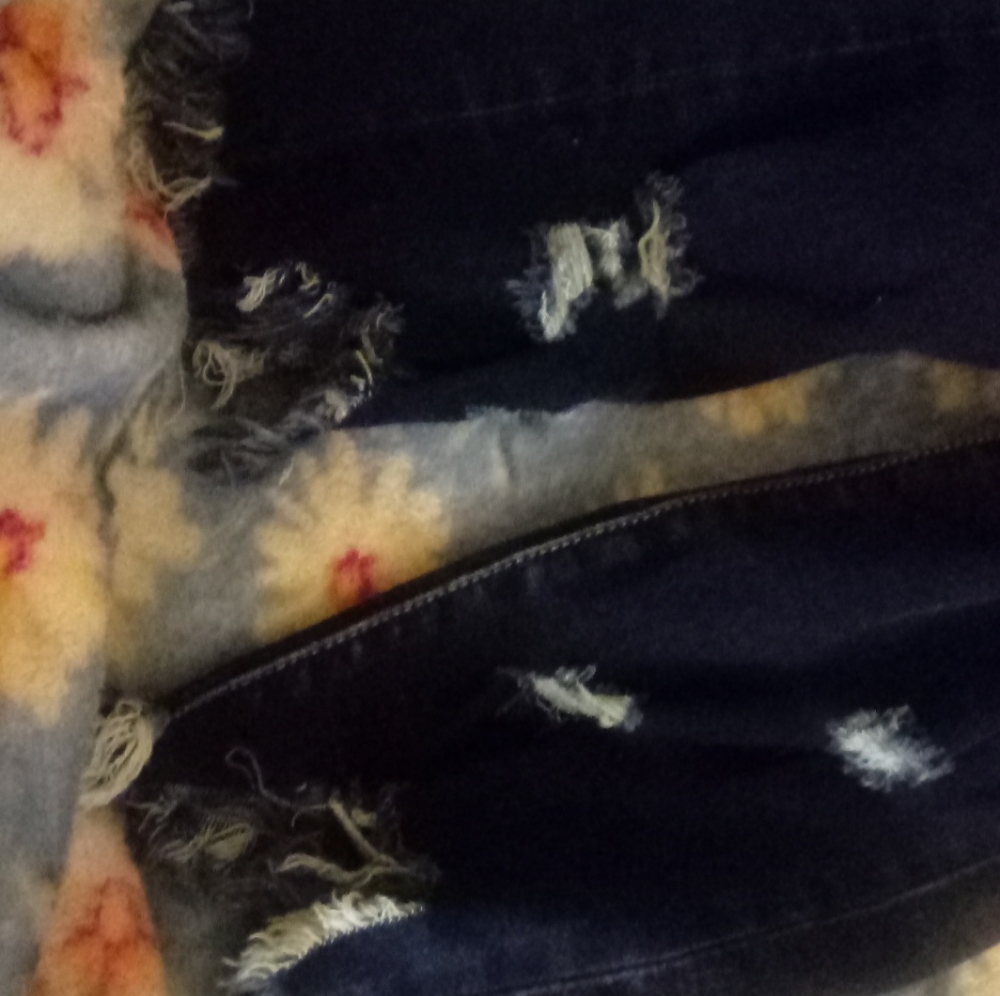 Blue jeans with Rips at bottom of legs